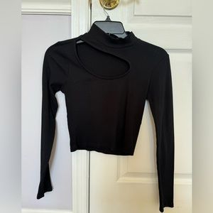 Black Turtleneck with a cut around the chest area
